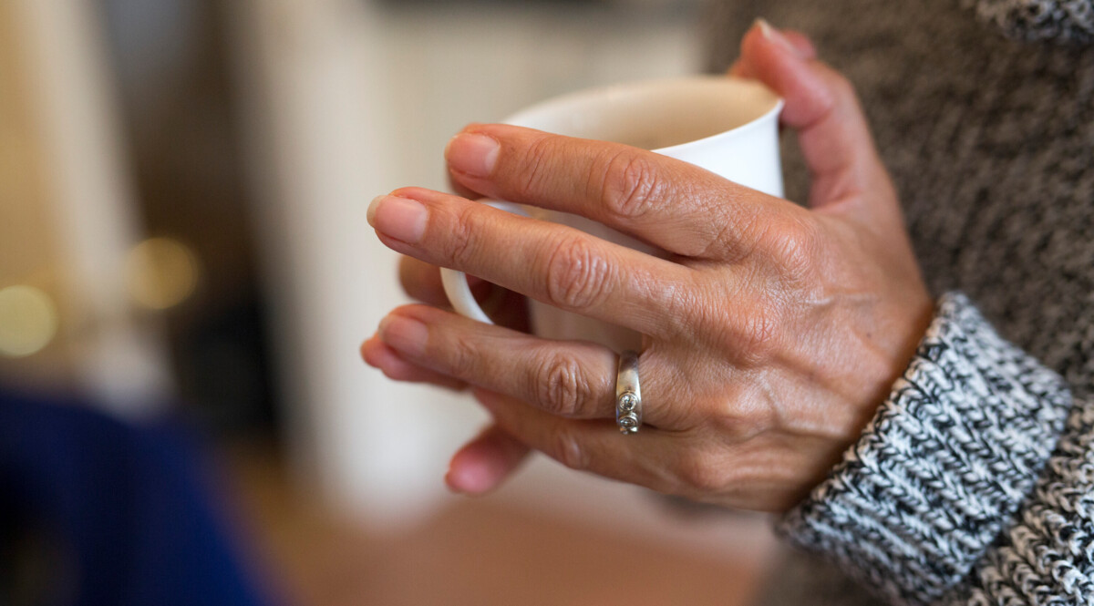Hands holding a mug