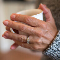 Hands holding a mug