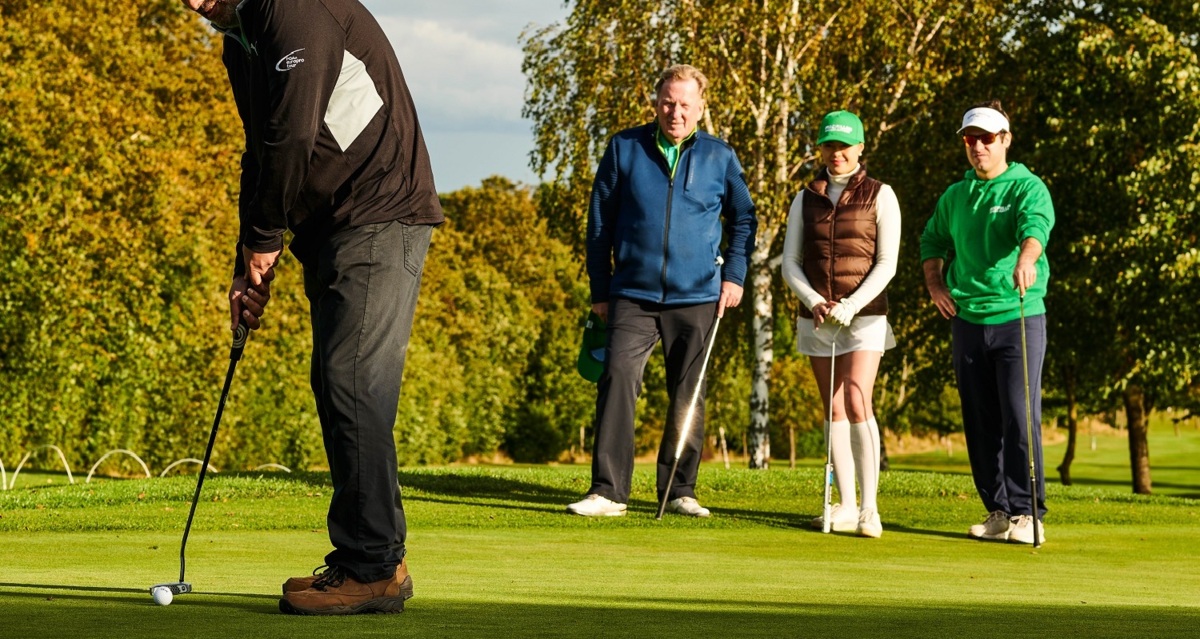 Three male golfers and a female golfer