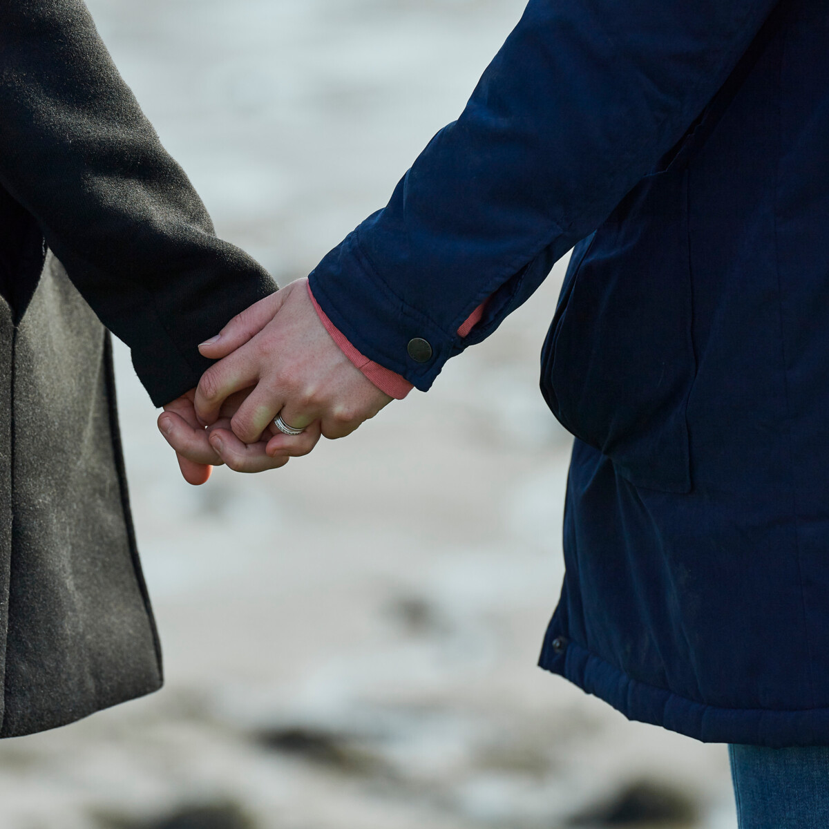 A close-up of a couple holding hands