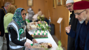 A woman serving cake at an Iftar