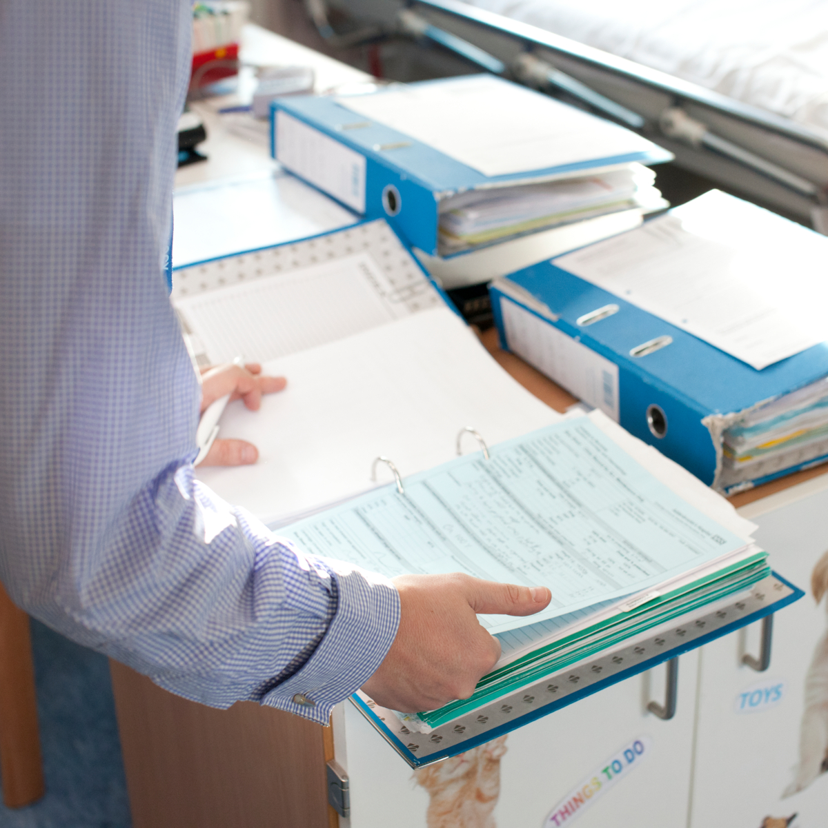 A male health professional looking through some medical files