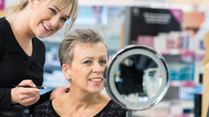 A Boots beauty adviser showing a woman make-up techniques