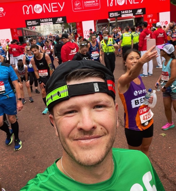 Reece at the finishing line of a marathon for Macmillan 