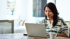 A woman working on a laptop. 