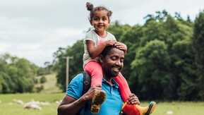 A father and young daughter out for a walk