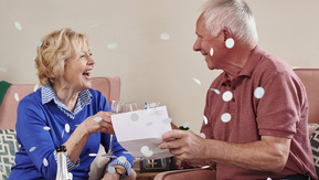 A couple toasting over their raffle winner letter 