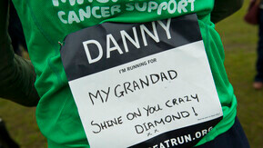A green Macmillan running shirt with a handwritten dedication on the back saying I'm running for my grandad, shine on you crazy diamond!
