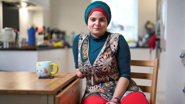 Woman sitting at table with a cup of tea