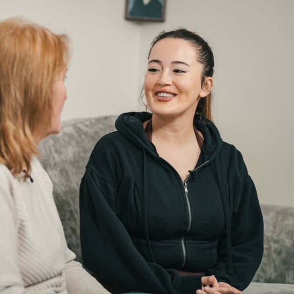 Blood cancer awareness month. Image of two women talking on sofa.