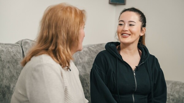 Blood cancer awareness month. Image of two women talking on sofa.