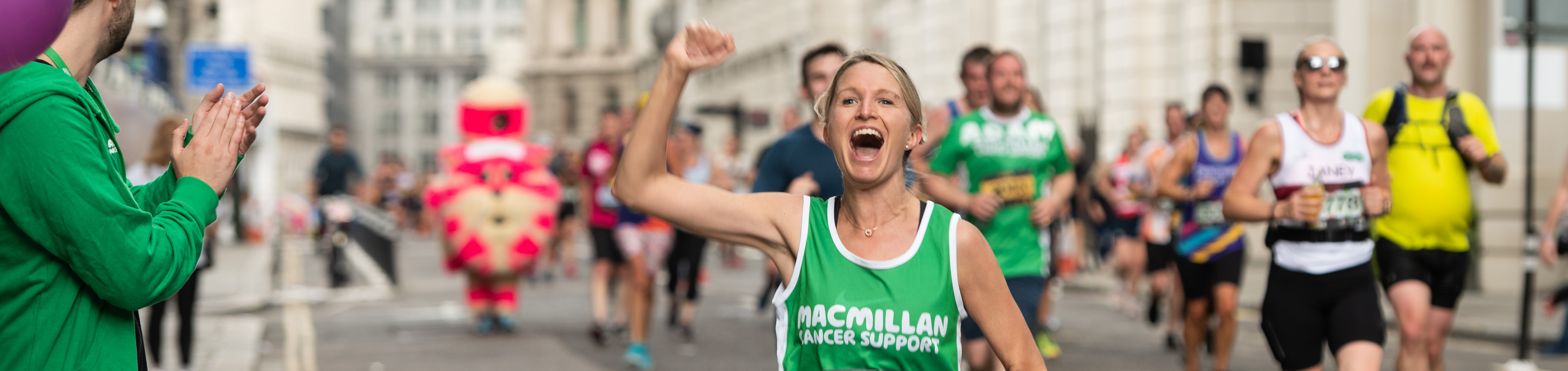 A Macmillan runner with her arm in the air