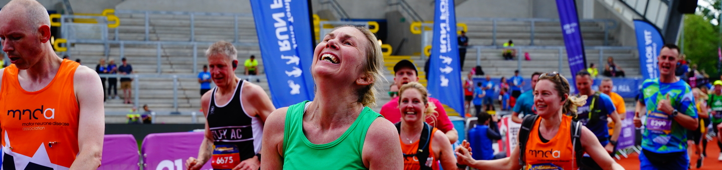 A Macmillan runner at the end of her race, looking hot and tired.