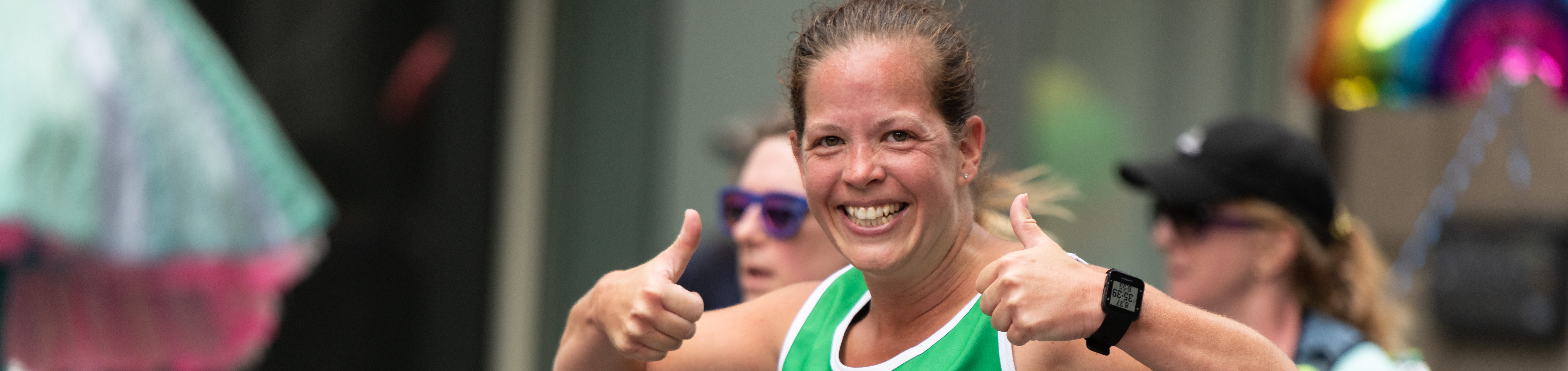 Macmillan runner with her thumbs up and smiling