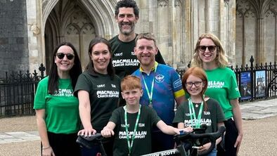 Simon at the finish of his challenge with his bike and supporters