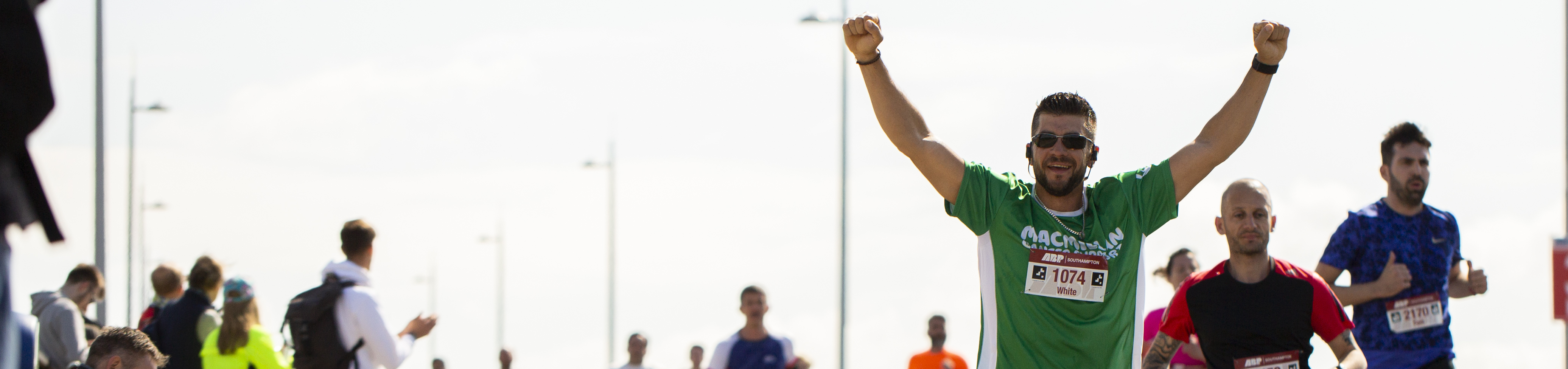 Macmillan runner with his arms raised above his head