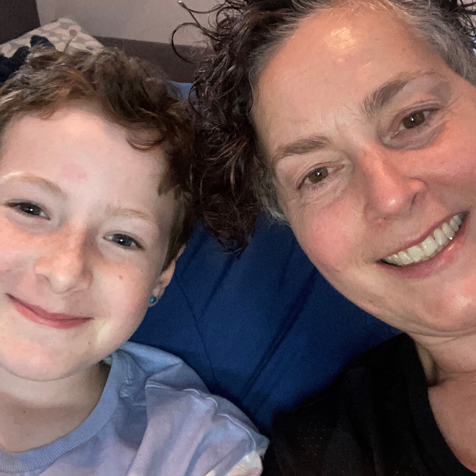 A child with their mum smiling.