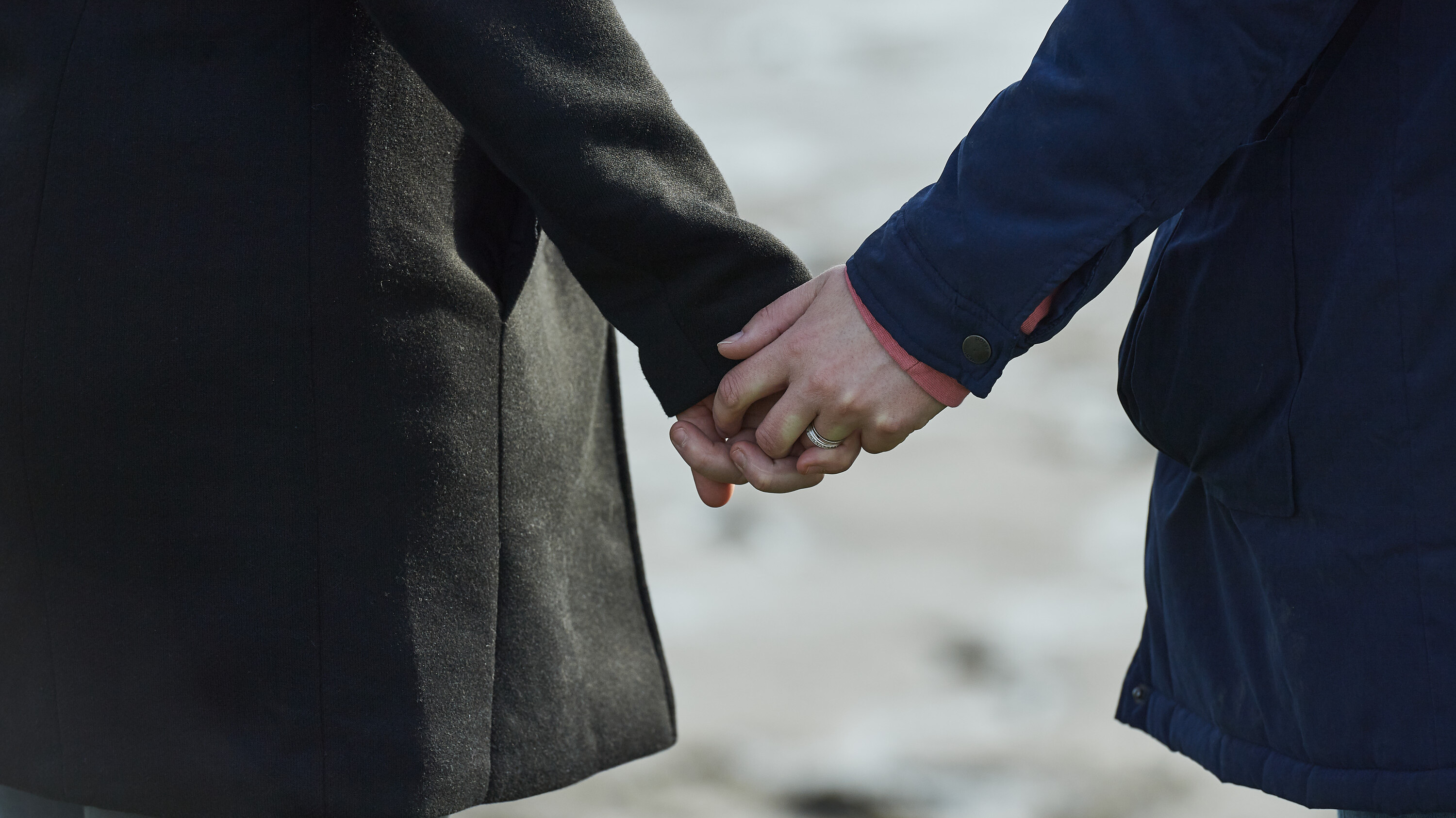 A close-up of a couple holding hands