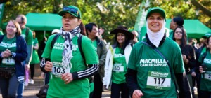 A group of people wearing Macmillan t-shirts and walking