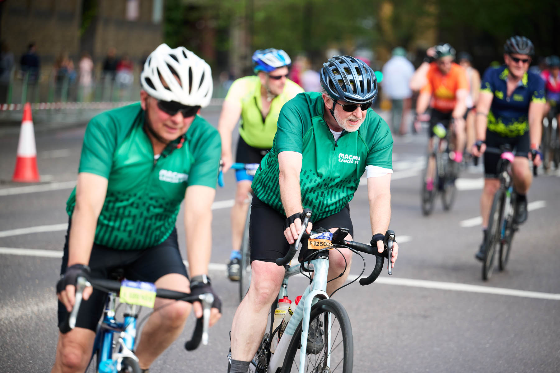 A group of cyclists taking part in the cycling stage of an Ironman event.