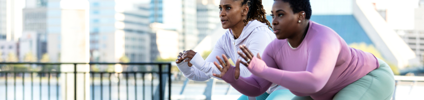 Two women doing squats