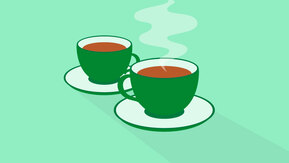 Two dark green teacups on a light green background.