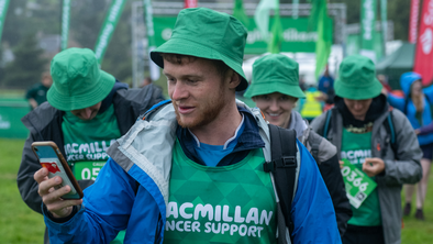 Michael looking at his phone while on a Mighty Hike