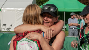 Two Mighty Hikers hugging at the finish