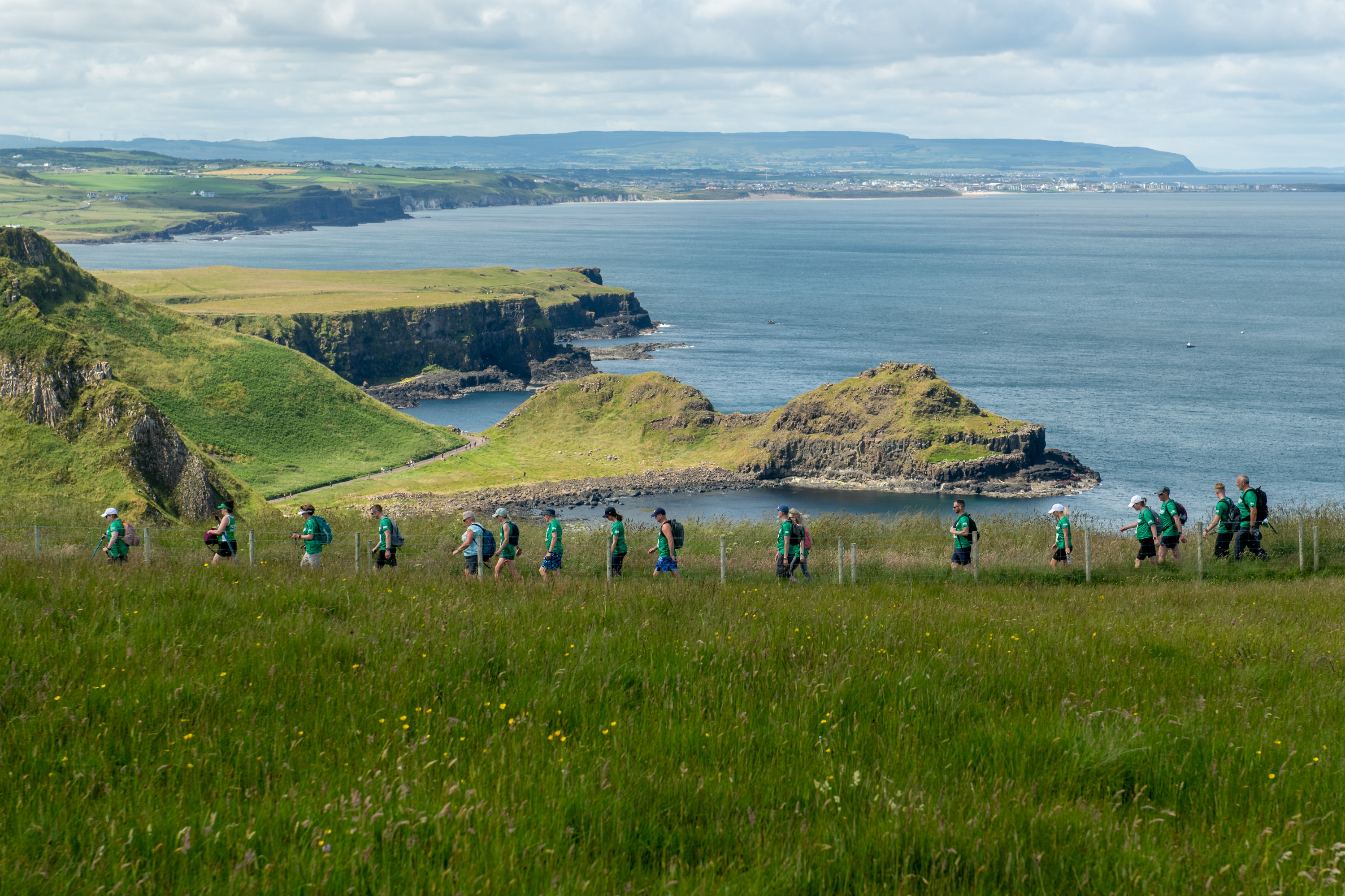 Might Hikers walking across the Giant's Causeway coastline
