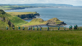 Might Hikers walking across the Giant's Causeway coastline