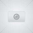 Several blueberry and orange crumble muffins in white muffin wrapping are viewed from above. Some are placed on a table and others on a cooling rack. Next to the muffins are several blueberry muffins. 