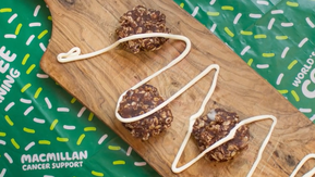 Cookies with coconut cream drizzled on top on a wooden board