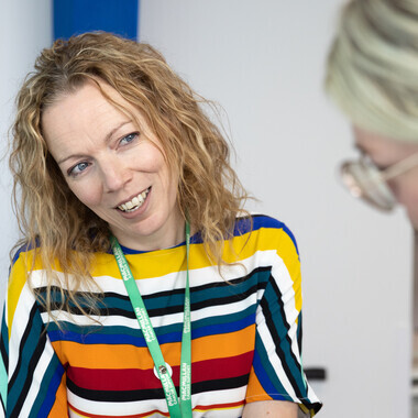 A doctor is talking to another healthcare professional