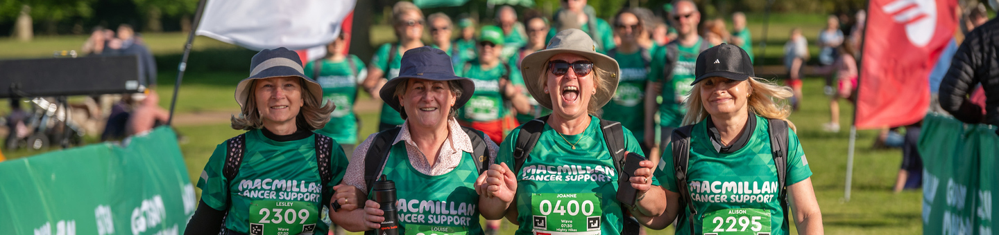 Four Mighty Hikers walking over the finish line