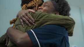 Two black women hugging