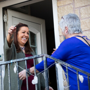 Alison, diagnosed with cervical cancer meeting friend outside home