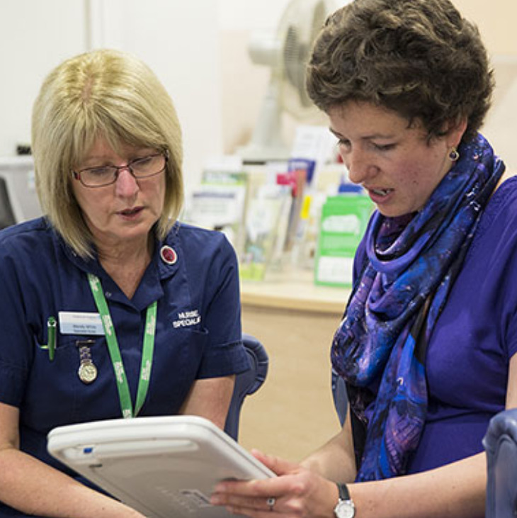 Photo of a Macmillan nurse talking to a patient