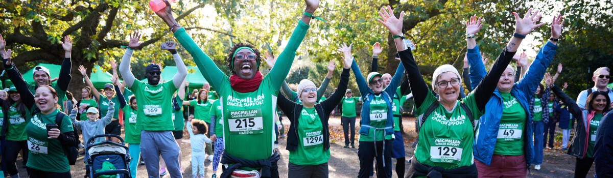 Group of Macmillan runners cheering with their hands in the air