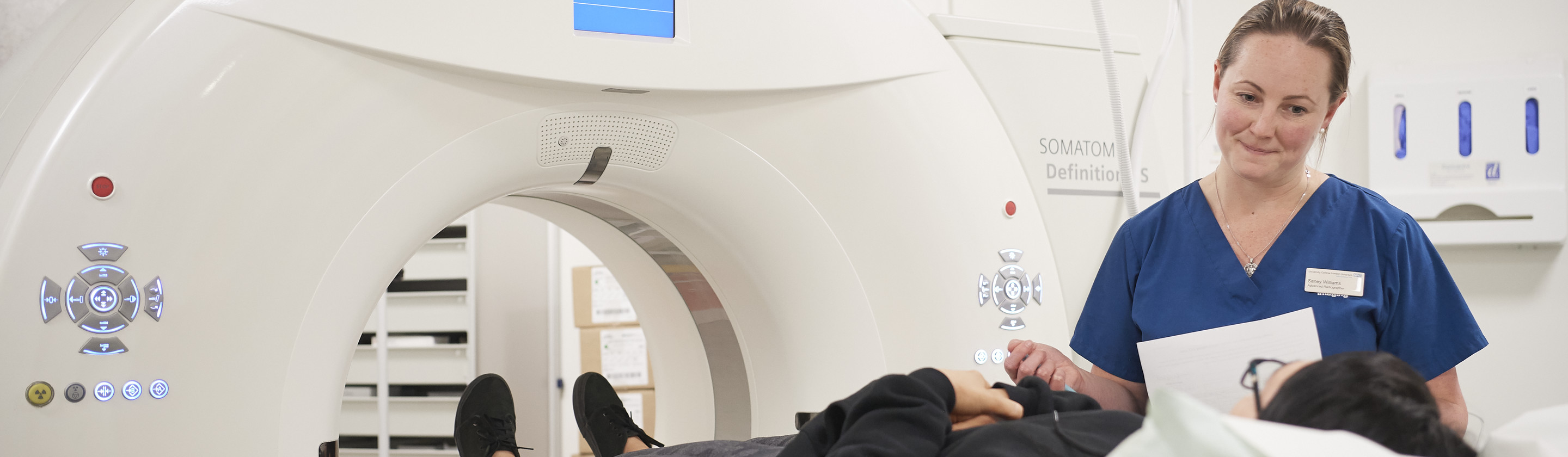 A Macmillan professional with a patient before an MRI scan