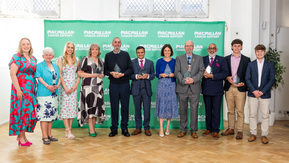 Winners of the 2024 Thanks to You awards standing in a line holding their awards.