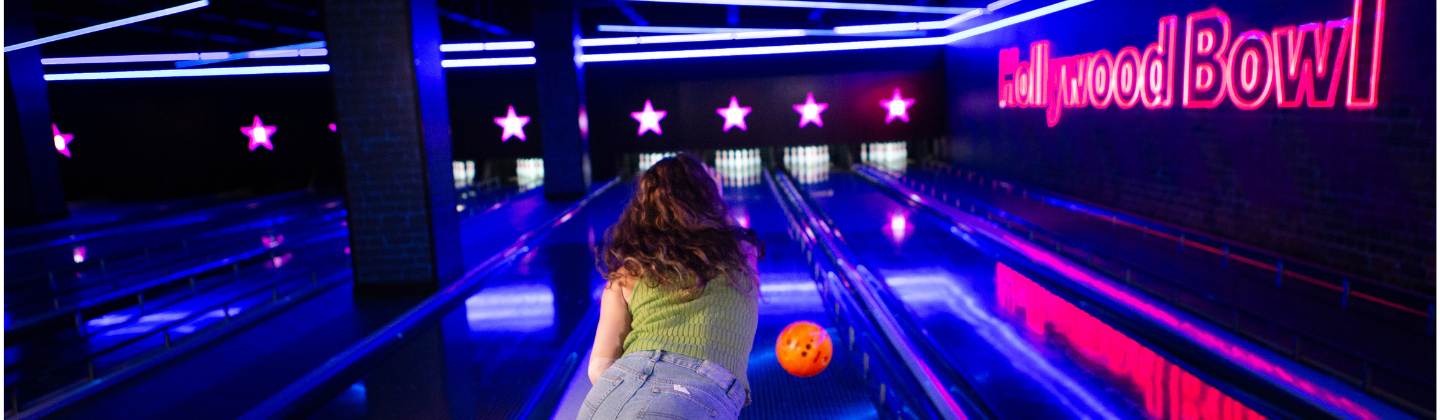 A woman playing ten pin bowling