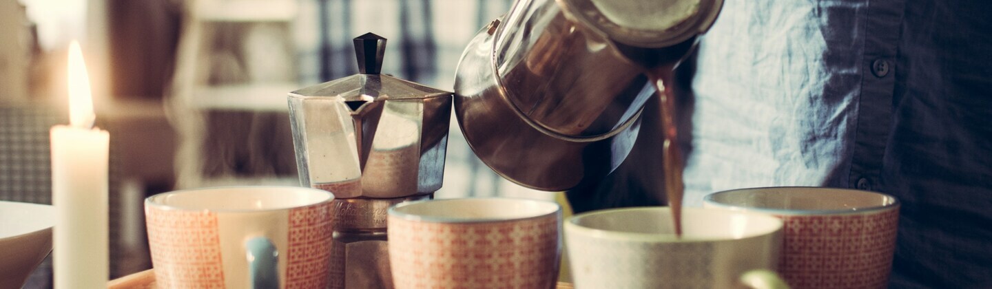 Cups being filled with hot coffee