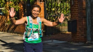 Woman running holding hands up to the camera