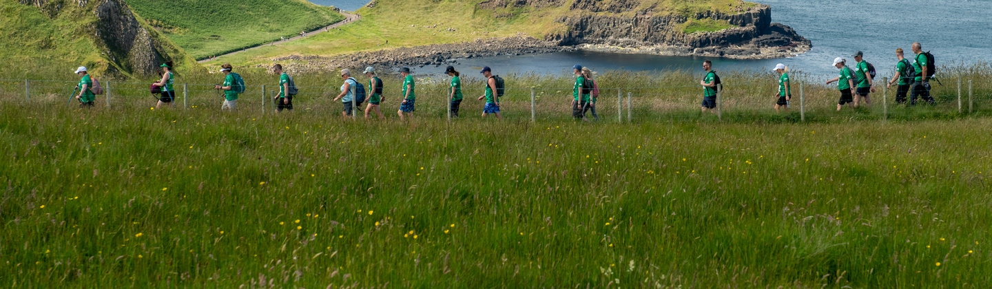 Might Hikers walking across the Giant's Causeway coastline