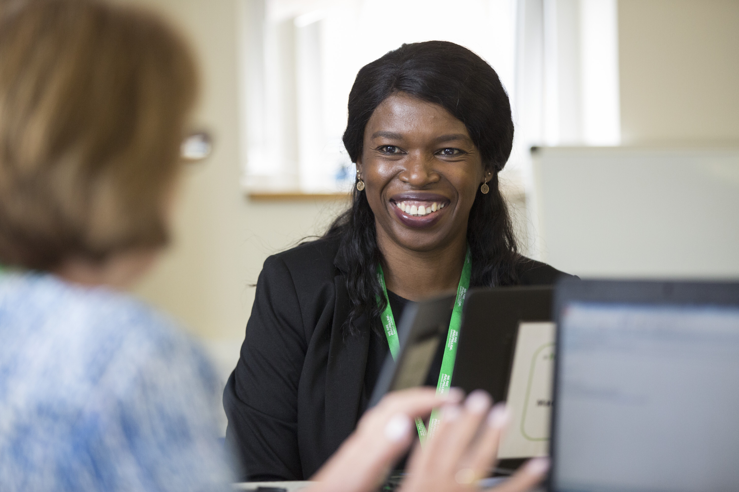Kemi, Macmillan Clinical Education Project Lead, smiling while talking to a colleague at work