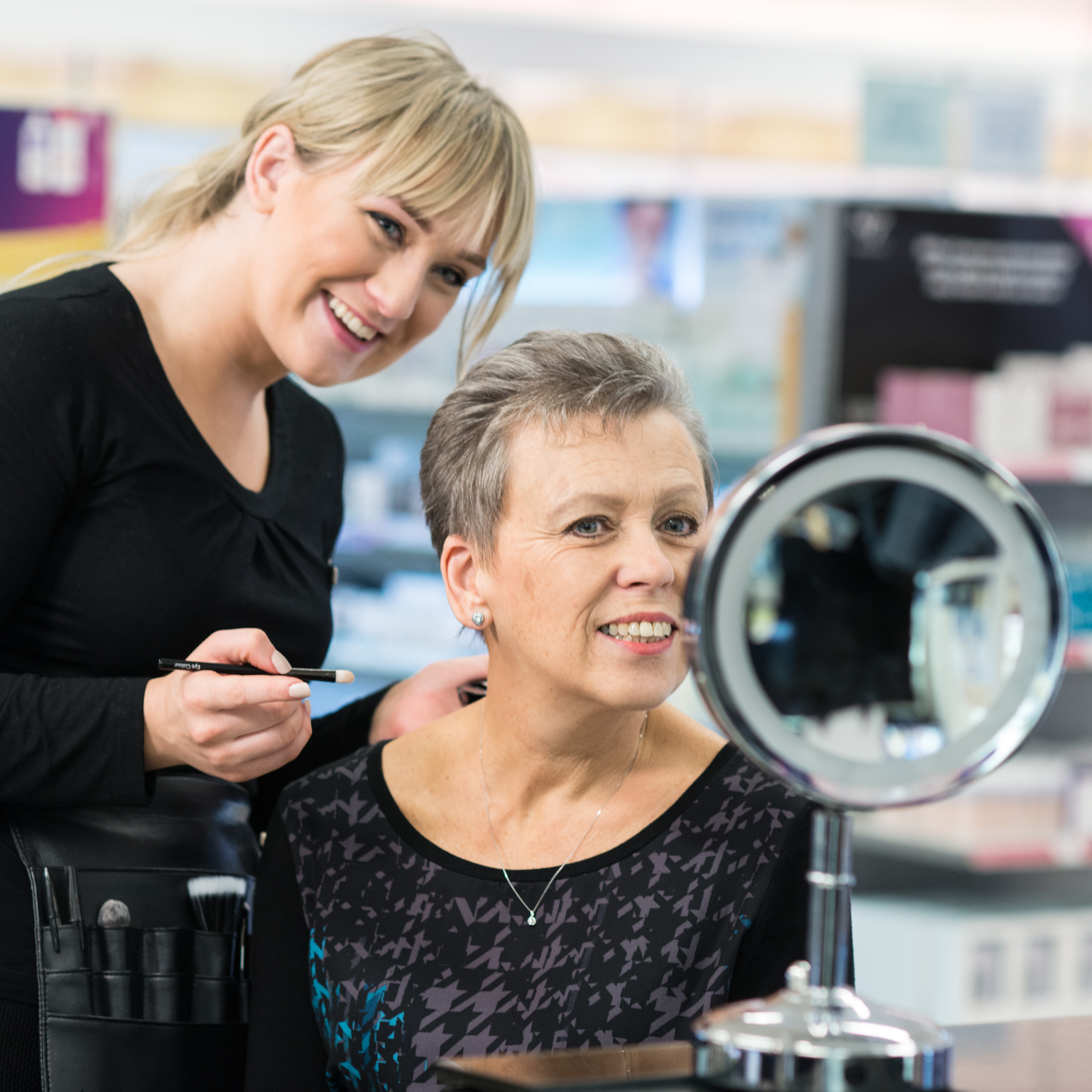 A Boots beauty adviser showing a woman make-up techniques