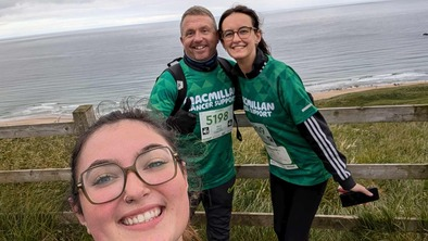 Kajia with fellow hikers smiling with the sea in the background