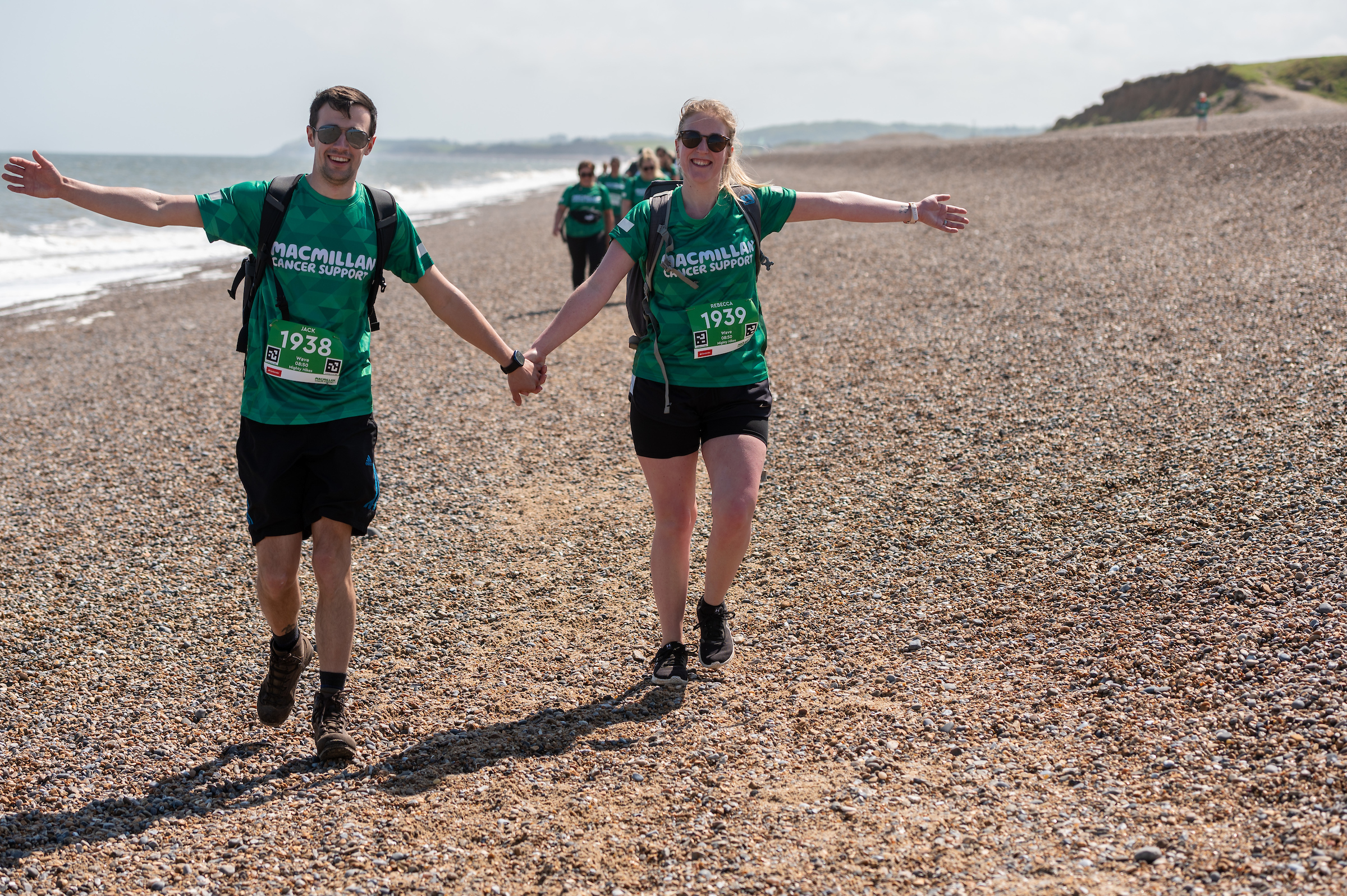 Mighty hikers walking hand in hand on the beach