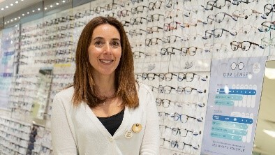 A lady with long brown hair working in Boots opticians