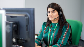 Macmillan support line employee working on computer